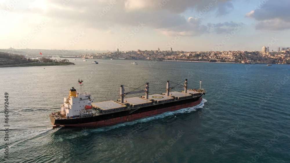 Aerial front view Container cargo ship full carrier container with terminal commercial port background for business logistics, import export, shipping or freight transportation.