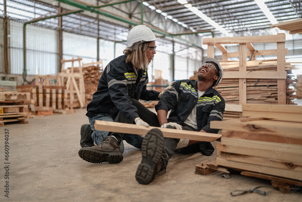 Foreman injured from accident lying on floor crying with pain in warehouse. Female worker emergency help male colleague who falling down get physical injury in workplace. Risk, dangerous in workplace Foreman injured from accident lying on floor crying with pain in warehouse. Female worker emergency help male colleague who falling down get physical injury in workplace. Risk, dangerous in workplace