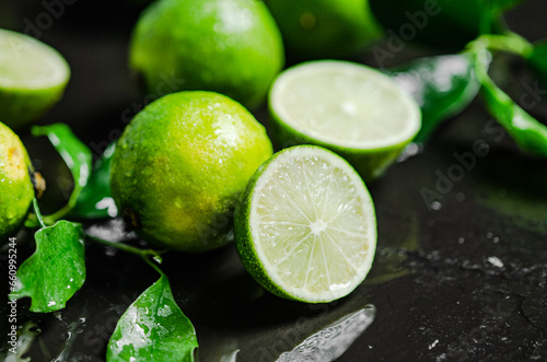 Fresh limes. On black table.