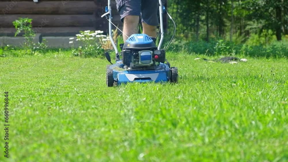 Lawn mower cutting grass. Small grass cuttings fly out of lawnmower. Grass clippings get spewed out of a mower pushed around by landscaper. CloseUp. Gardener working with mower machine. Mowing lawns
Lawn mower cutting grass. Small grass cuttings fly out of lawnmower. Grass clippings get spewed out of a mower pushed around by landscaper. CloseUp. Gardener working with mower machine. Mowing lawns