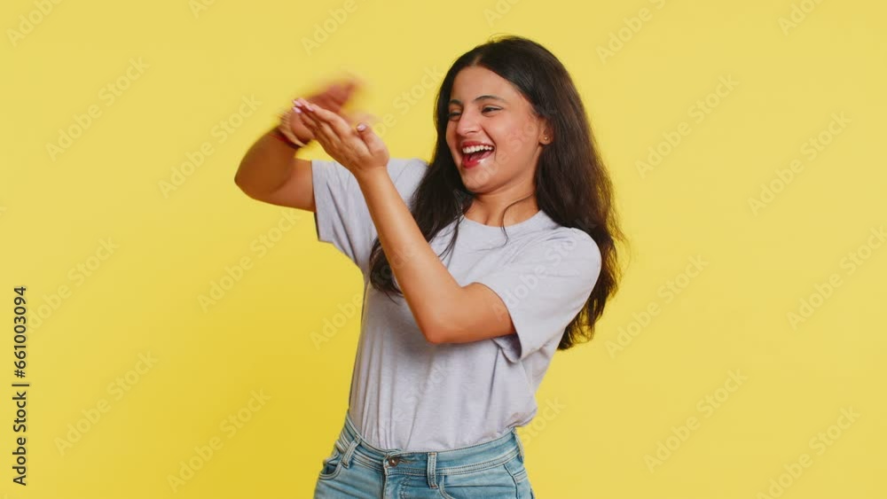 Indian woman showing wasting throwing sharing money around more tips big profit winning lottery jackpot, successful shopping payment purchase cashback. Arabian Hindu girl isolated on yellow background Indian woman showing wasting throwing sharing money around more tips big profit winning lottery jackpot, successful shopping payment purchase cashback. Arabian Hindu girl isolated on yellow background