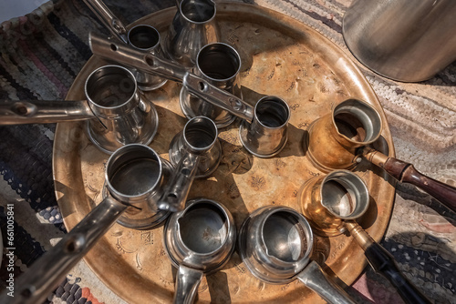 Top view of various metal cezves in coffee shop photo