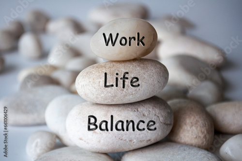 Work life balance text engraved on white stones. New ways of working concept. photo