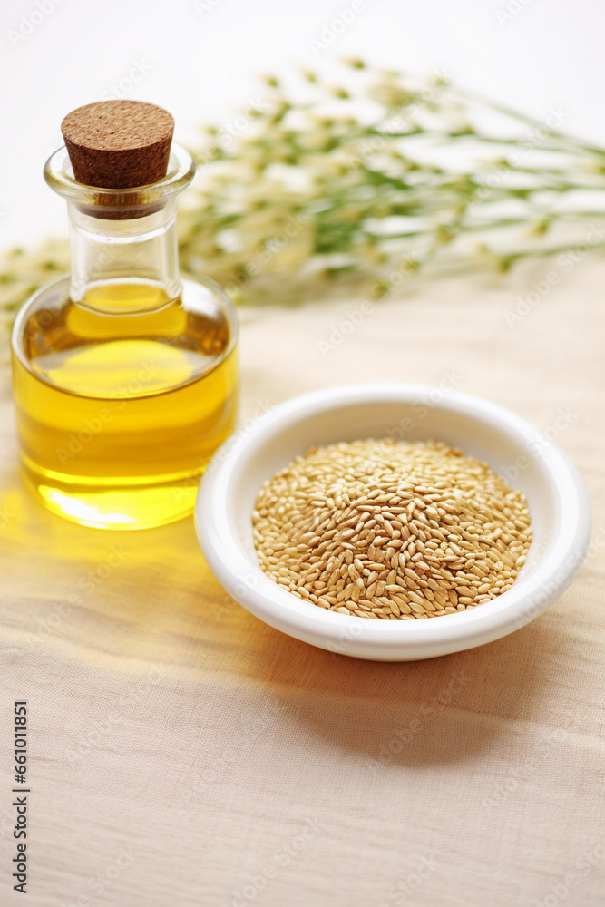 Fresh sesame oil and seeds on white background Fresh sesame oil and seeds on white background