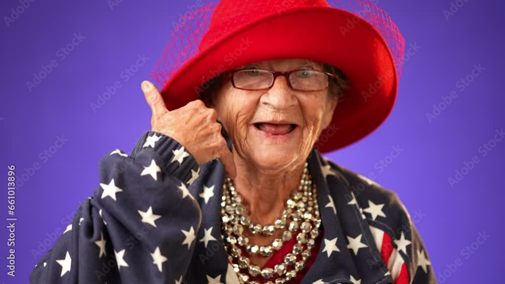 Funny closeup portrait of smiling happy elderly toothless senior old woman with wrinkled skin smiling pointing to camera and giving call me gesture with hands isolated on solid purple background. Funny closeup portrait of smiling happy elderly toothless senior old woman with wrinkled skin smiling pointing to camera and giving call me gesture with hands isolated on solid purple background.