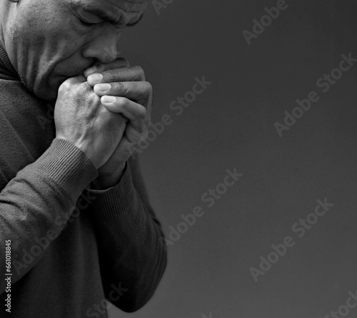 black man praying to god on gray background with people stock image stock photo
