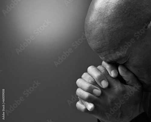 black man praying to god on gray background with people stock image stock photo