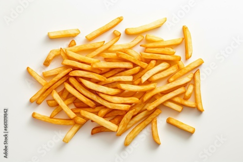 An overhead perspective of crispy golden french fries spread out on a plain white table. Thin deep-fried potato sticks. Generative AI
