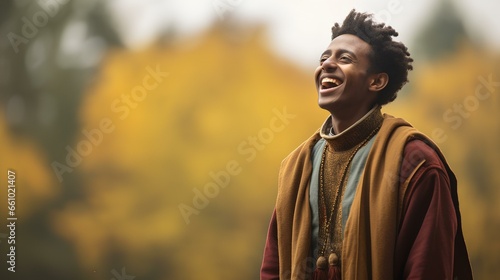 a African Ethiopian male gospel singer, dressed in earthy, fall-inspired clothing, singing passionately amidst the autumn colors. generative AI photo