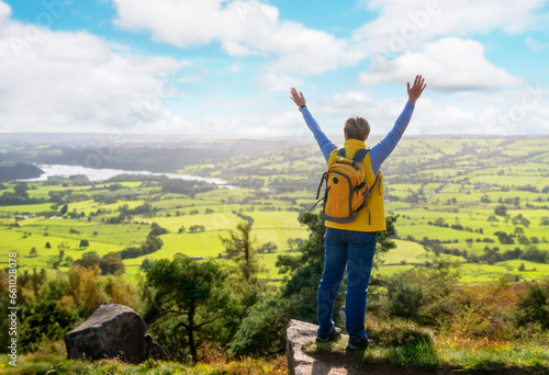 Stunning Woman reaching the destination and taking selfie, photos, and shouting on the top of mountain Travel Lifestyle concept The national park Peak District in England photo