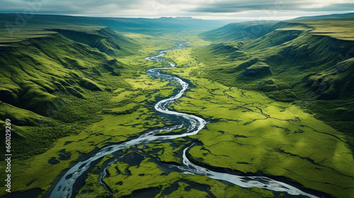 Aerial view of a green valley with a small river in Iceland highlands.