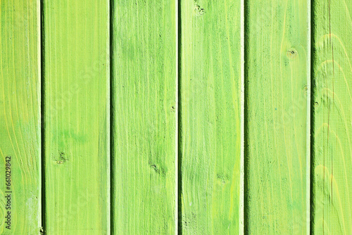 Vertical green wood background. Green paint wood texture. Vibrant color plank. Board structure. Lime color impregnated outdoor wood pattern. Bright backdrop. Wooden stripes. Natural lines pattern.