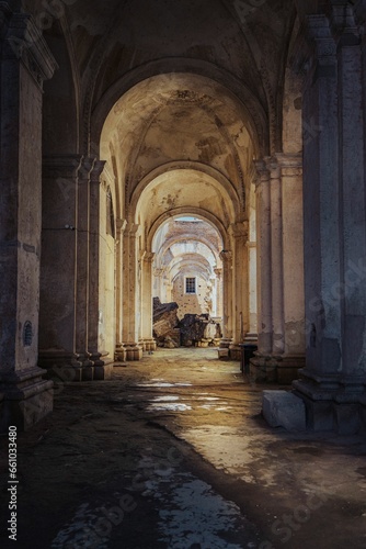 a street that is very dark with a bunch of arches