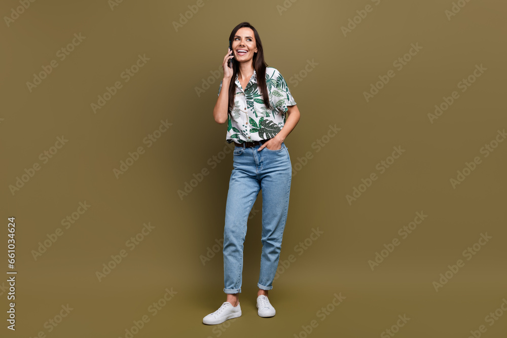 Full size photo of cheerful lovely girl good mood talk communicate telephone isolated on brown color background Full size photo of cheerful lovely girl good mood talk communicate telephone isolated on brown color background