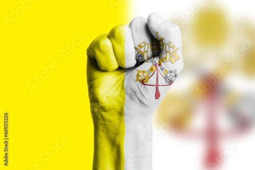 Man hand fist of VATICAN flag painted. Close-up.