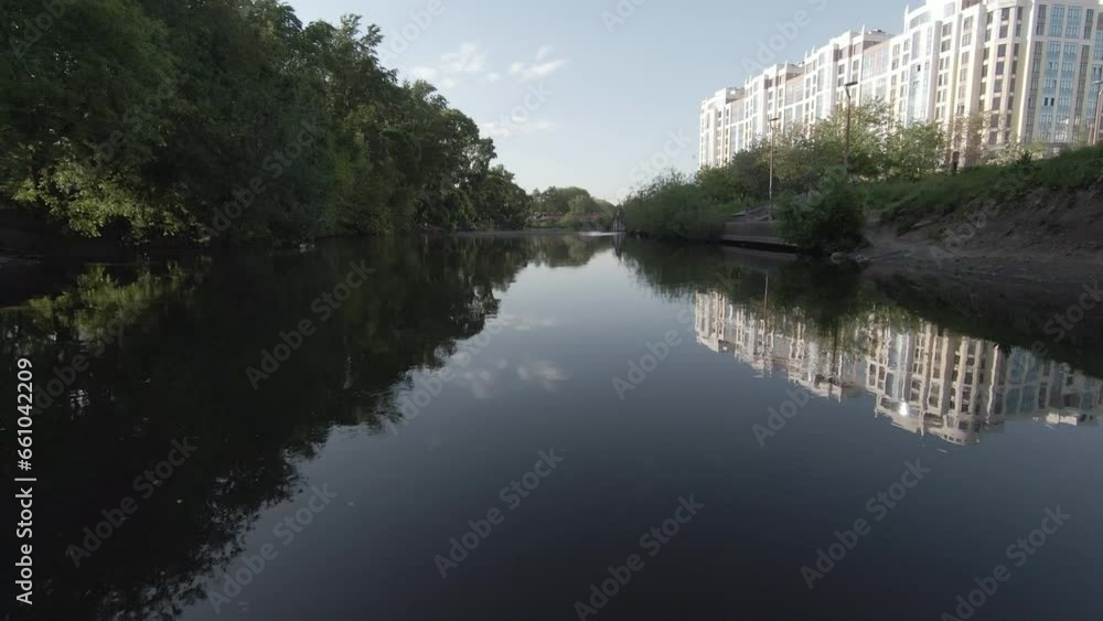 Aerial flight over the river in the city park of Yekaterinburg. Footage. Fly under the bridge. Bird's eye view of the Iset river near the Circus. Rest of people in the park, flights of birds Aerial flight over the river in the city park of Yekaterinburg. Footage. Fly under the bridge. Bird's eye view of the Iset river near the Circus. Rest of people in the park, flights of birds