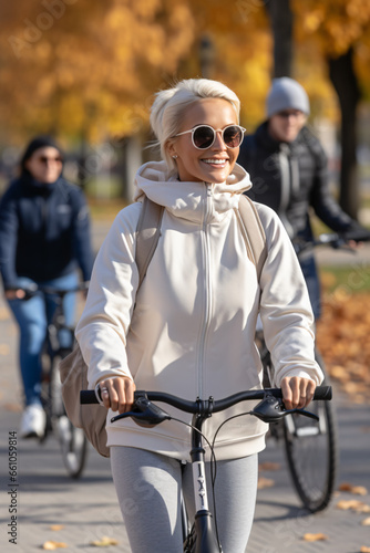 Young modern woman riding electric scooter in the park. Natural and sunny environment. Joyful mood. Individual means of transportation. Outdoor recreational activity concept. Ecology.