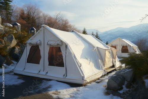 Winter camping retreat White tents nestled in a mountain resort photo