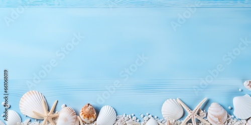 Evoking the essence of summer with a flat lay of seashells delicately arranged on a blue wooden banner background, this photo also provides ample empty space for custom use.