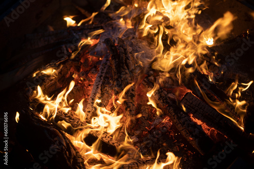 Flames of pyre. Yellow light. Firewood burning in fire.