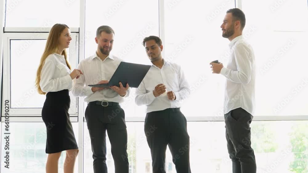Smiling diverse businesspeople having a discussion while collaborating on a new project with laptop in an office Smiling diverse businesspeople having a discussion while collaborating on a new project with laptop in an office