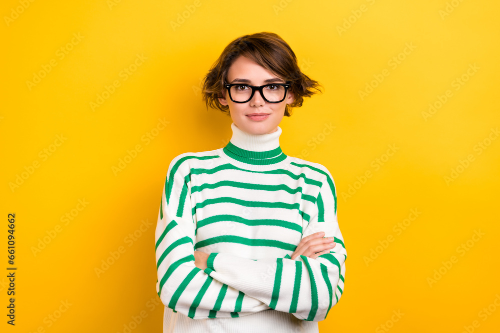 Photo of confident pretty lady wear striped pullover spectacles arms crossed isolated yellow color background Photo of confident pretty lady wear striped pullover spectacles arms crossed isolated yellow color background