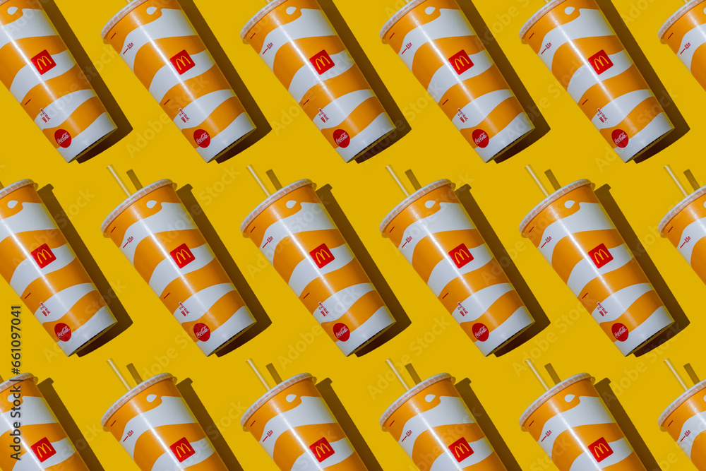 Yellow glass of McDonald's. Paper cup with lid. Takeaway drink ...