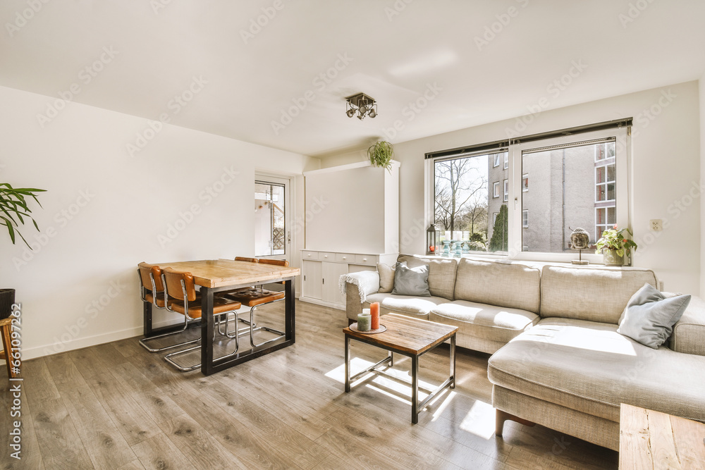 Living room with dining table and sofa by window Living room with dining table and sofa by window