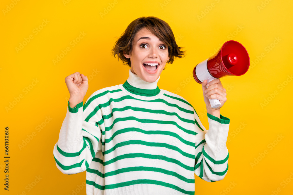 Photo of overjoyed delighted girl hand hold loudspeaker raise fist success achievement isolated on yellow color background Photo of overjoyed delighted girl hand hold loudspeaker raise fist success achievement isolated on yellow color background