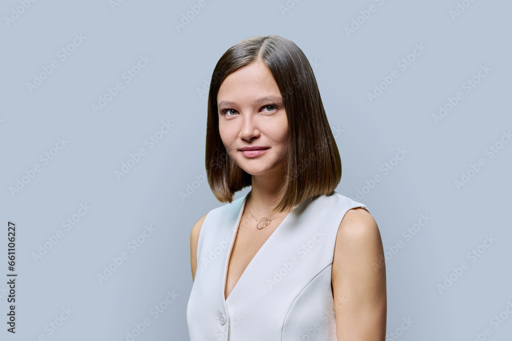 Portrait of young elegant business woman, on gray studio background Portrait of young elegant business woman, on gray studio background