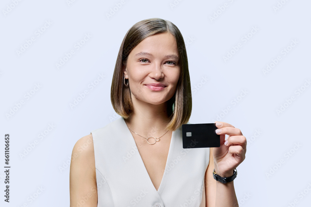 Young woman bank employee showing credit card, on white background Young woman bank employee showing credit card, on white background