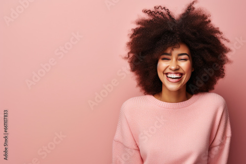 Giggling Young African American Woman with Big Natural Hair, Pink Sweater, Curly Locks