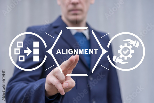 Man using virtual touch screen presses word: ALIGNMENT. Business alignment strategy concept. Ideas for creativity. Ordering or alignment.