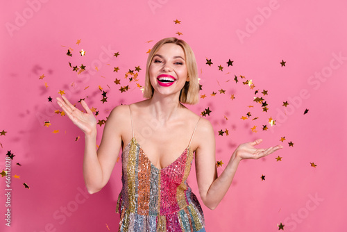 photo of adorable positive lady celebrate new year occasion in night club with flying confetti isolated pastel color background