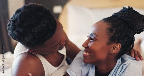 Hug, forehead kiss and a black couple on a bed for happiness, comfort and relax together. Smile, house and an African man and woman with affection, care and love in the bedroom in the morning photo