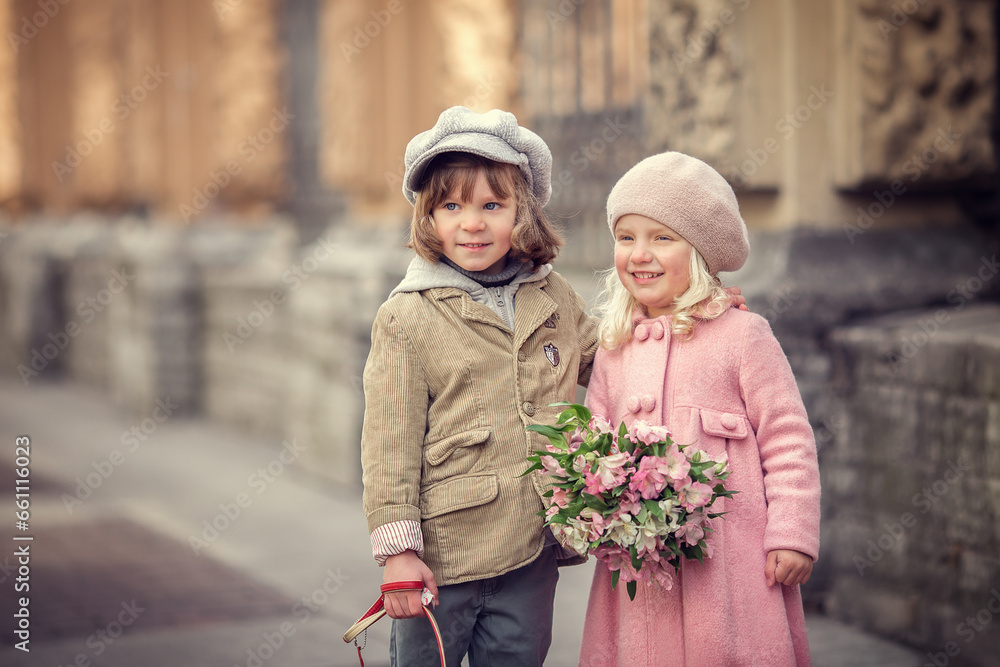 Girl and boy with flower bouquet on the city street talking and laughing in spring Girl and boy with flower bouquet on the city street talking and laughing in spring