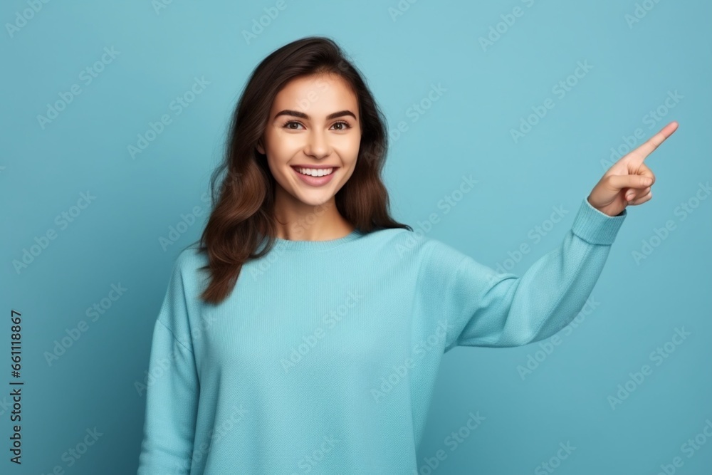 cheerful young beautiful and stylish female model posing against blue background cheerful young beautiful and stylish female model posing against blue background
