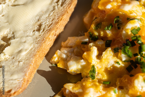 Scrambled eggs with chives and light bread with butter.
