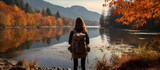 roam alone young adult female traveller standing relax carefree casual explore nature scenery autume forest and rever lake stunning peaceful background
