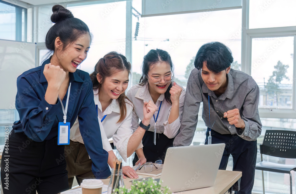 Group of Young Asian business team creative businesspeople coworker in office Happy to be successful partnership teamwork celebrating achievement and success concept. Group of Young Asian business team creative businesspeople coworker in office Happy to be successful partnership teamwork celebrating achievement and success concept.