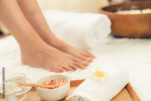 Panorama top view woman indulges in blissful foot massage at luxurious spa salon while masseur give reflexology therapy in gentle day light ambiance resort or hotel foot spa. Quiescent