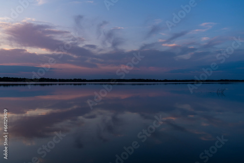 Colorful cloud formation with reflection during sunset at North Turtle Lake in Minnesota, USA. 