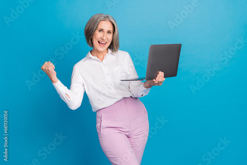 Photo of cheerful lucky woman dressed white shirt online sale shopping modern device isolated blue color background