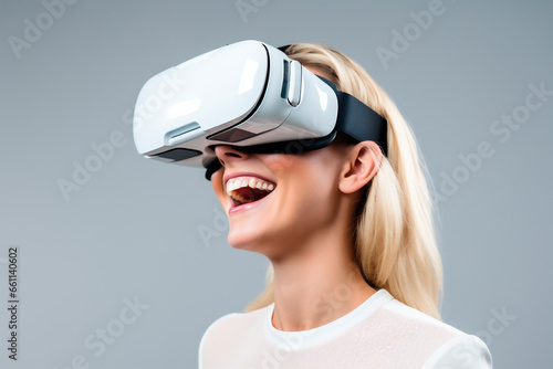 Portrait of young blonde woman enjoying and smiling with virtual reality goggles with white t-shirt and glasses.