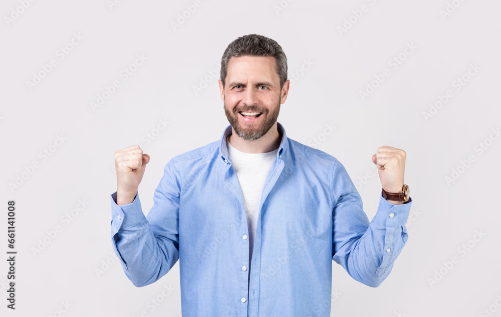 cheerful winning man win with yes gesture. winning man win with yes gesture wearing shirt. cheerful winning man win with yes gesture. winning man win with yes gesture wearing shirt.