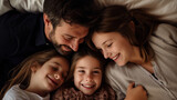 Top shot happy family lying on the bed