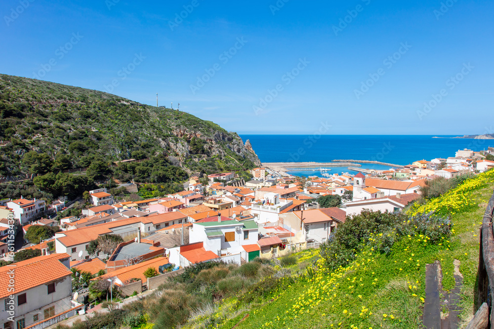 view from the top of the hill onto a beautiful and picturesque town Buggerru, Sardinia, Italy lying on the seashore of Mediterranean sea