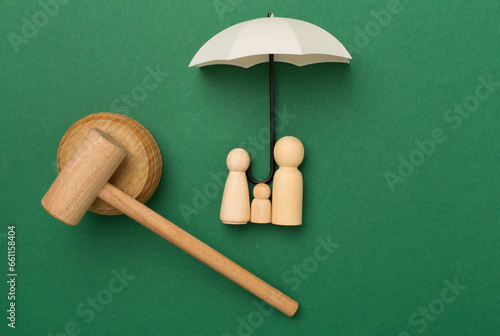 Wooden family figures with judge's gavel on color background,top view