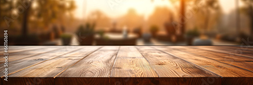 Wooden table top with blurred background to insert your products, panoramic format.