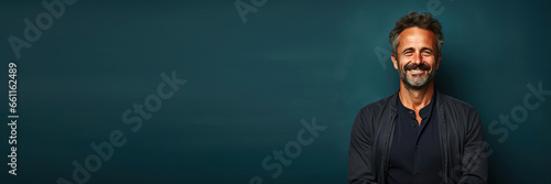middle age man smiling in front a green seamless background. Banner design with space for text